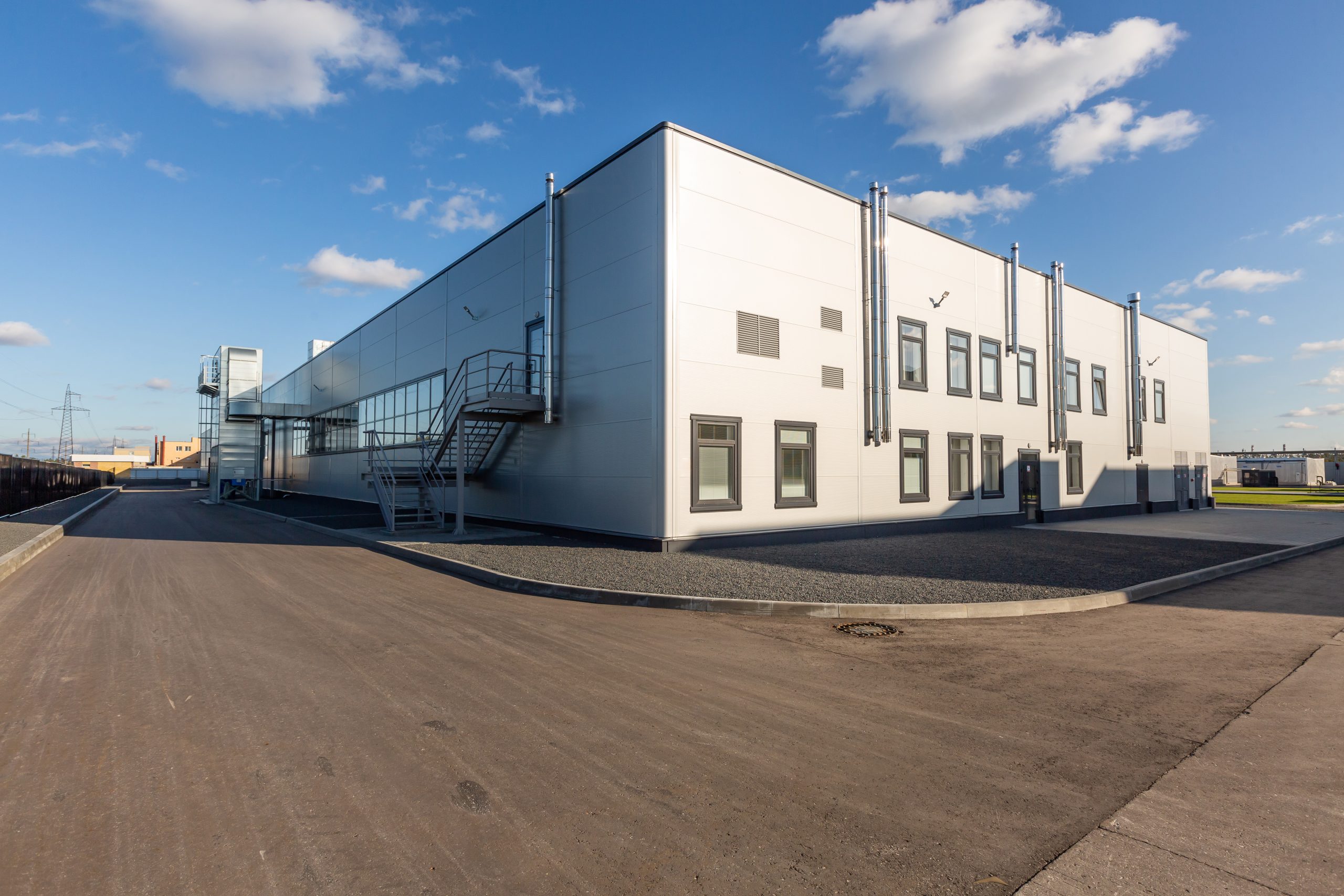 industrial enterprise appearance. Summer day, blue sky, small metal case industrial enterprise appearance. Summer day, blue sky, small metal case