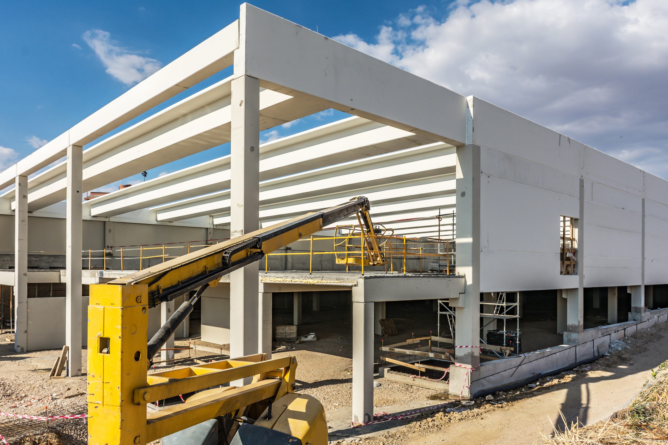 Construction site of an industrial warehouse with a mobile elevator Construction site of an industrial warehouse with a mobile elevator